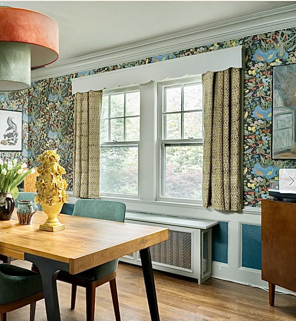Whimsical wallpapered dining room with short curtains